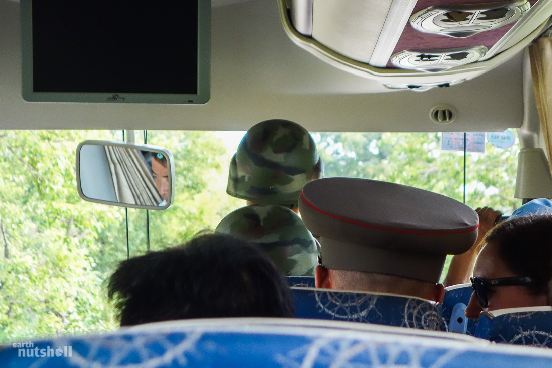 KPA accompanying us on the short drive into the DMZ, between tank traps and active minefield.